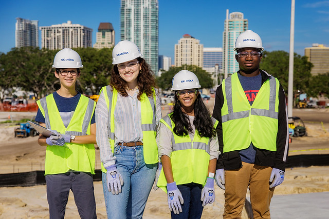 4 young ambassadors in construction helmets
